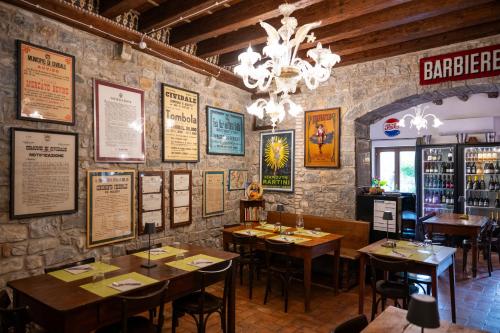 a dining room with tables and signs on the wall at 1448 Antica Dimora Al Merlo Bianco in Cividale del Friuli