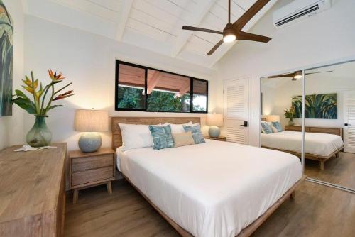 a bedroom with a large white bed and a mirror at Hoyochi Nikko 201 · HN 201 Relaxing Getaway OceanFront 2BD wPool in Kahana