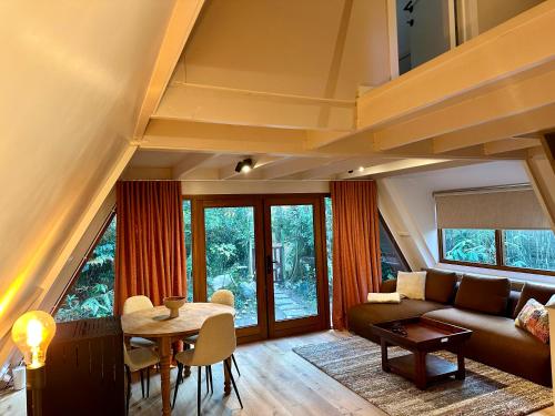 a living room with a couch and a table at Boshuisje Rekem - Sylva in Lanaken