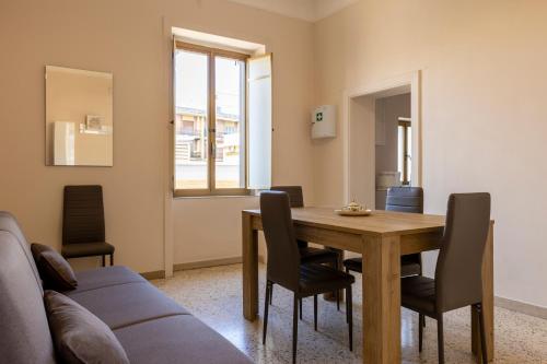 een eetkamer met een houten tafel en stoelen bij Domus Angelina Pompei in Pompei