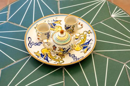 een bord met twee kopjes op een tafel bij Domus Angelina Pompei in Pompei