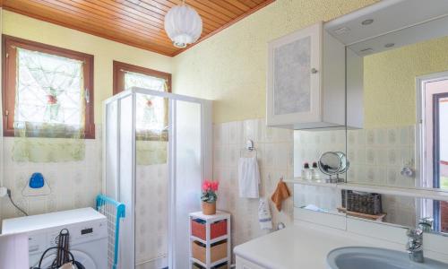 a bathroom with a sink and a mirror at maison chalet in Bessède-de-Sault