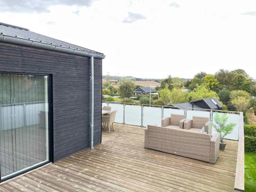 a deck with a couch on top of a house at Holiday Idyll With Nature And City Nearby in Skødstrup