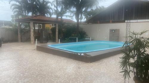 a swimming pool in front of a house at Casa Mar in Guaratuba