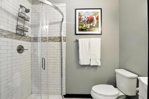 a white bathroom with a shower and a toilet at New Listing The 483 Suite - Walk to Stadium in Athens
