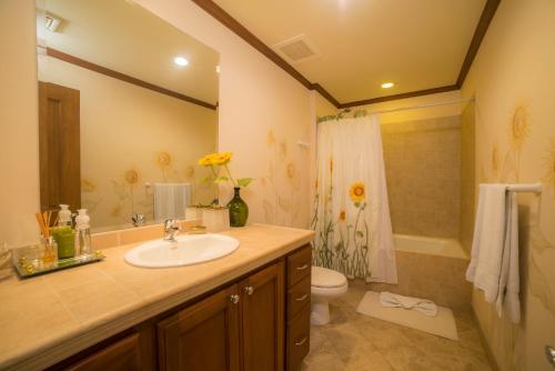 a bathroom with a sink and a toilet and a shower at Veranda 8H 3 bdr Garden View in Los Suenos in Herradura