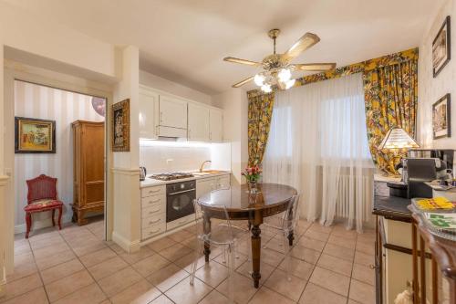 a kitchen with a table and a dining room at City Center Suite - In the elegant heart of Lecco in Lecco