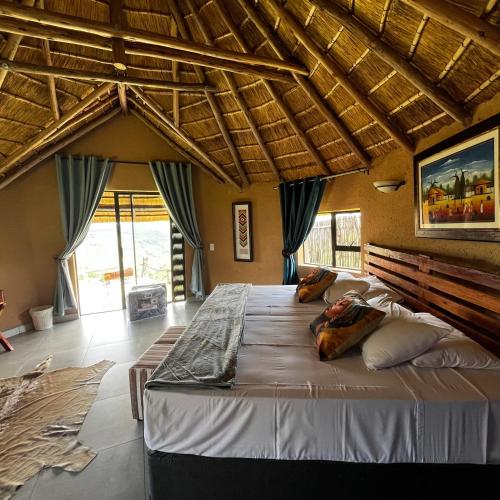 a bedroom with a large bed in a room at Mountain Aloe Den in Barberton