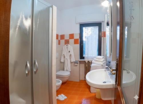 a bathroom with a sink and a toilet and a sink at Da Ernestina in Imperia