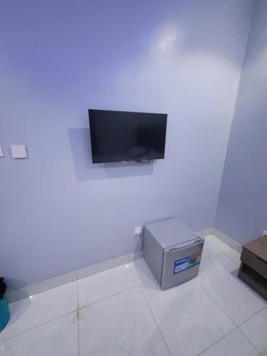 a room with a flat screen tv on a wall at Danamic view hotel in Abuja