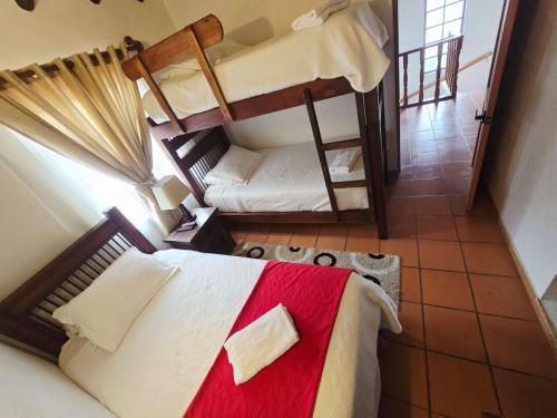 Cama o camas de una habitación en Aparta Hotel El Refugio de María