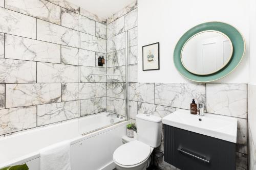 a bathroom with a sink toilet and a mirror at Judges Lodgings Boutique Hotel Apartments in Gloucester