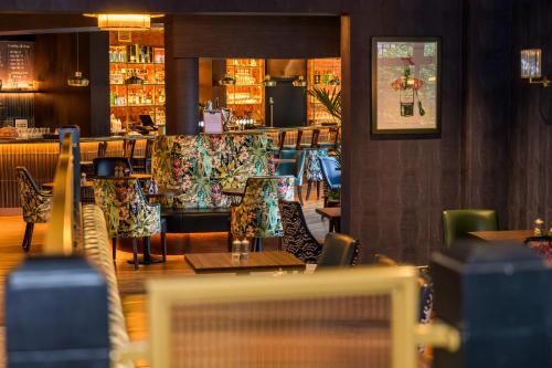 a restaurant with tables and chairs and a bar at Newtown Park Hotel in Wexford