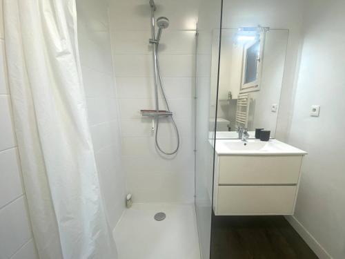 ein weißes Badezimmer mit Dusche und Waschbecken in der Unterkunft Maison rénovée avec jardin, wifi, BBQ, parking, à 250m de la mer - Pleumeur-Bodou - FR-1-368-14 in Pleumeur-Bodou