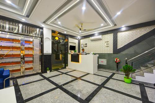 a lobby with a counter and a person in a room at Airport Hotel Dream World - Offering Free Airport Drop in New Delhi