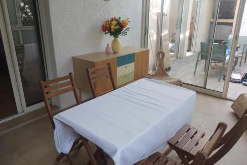 a room with a table and chairs with a box at Peaceful house in the heart of Boutonnet in Montpellier