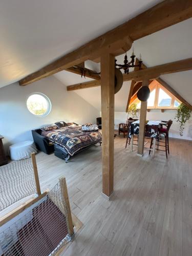 a living room with a bed and a table at Chez Clémence & Baptiste in Buhl-Lorraine