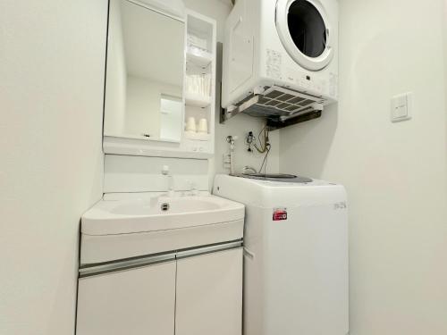 a white bathroom with a sink and a microwave at Grandioso Okinawa Villa Kin 2 - Vacation STAY 90150v in Yaka