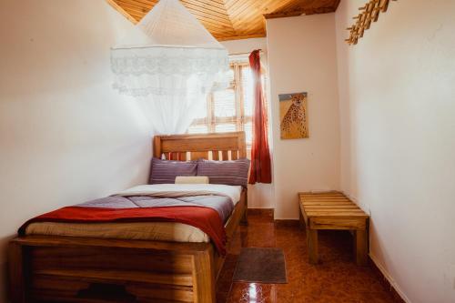 a bedroom with a bed in a room with a window at Meru Villa Arusha in Olmotoni