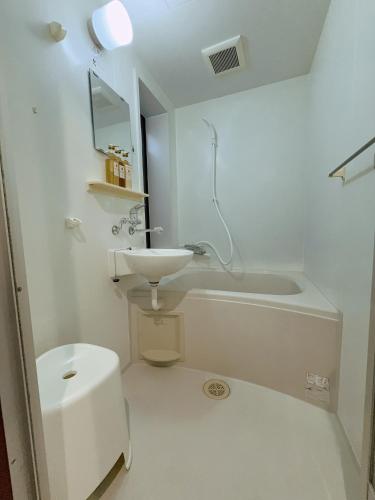 a bathroom with a sink and a tub and a toilet at YY-Minamicho 1 room-IT0339 in Tokyo