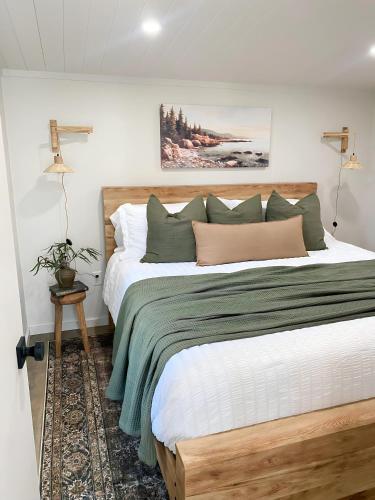 a bedroom with a large bed with a wooden headboard at Glamping Cabin I Best Bay Views I Near Restaurants in Gouldsboro