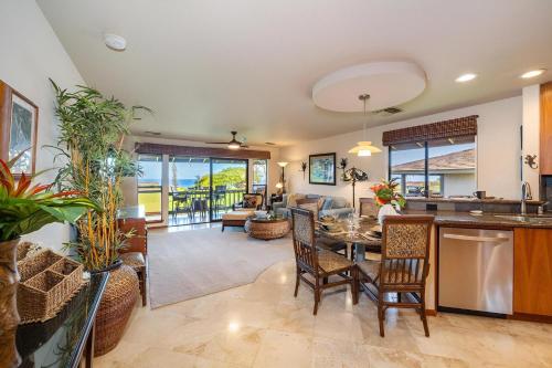 a kitchen and living room with a table and chairs at Kaanapali Plantation 57 · KPL 57 Hillside Haven | AC + BeachView in Lahaina