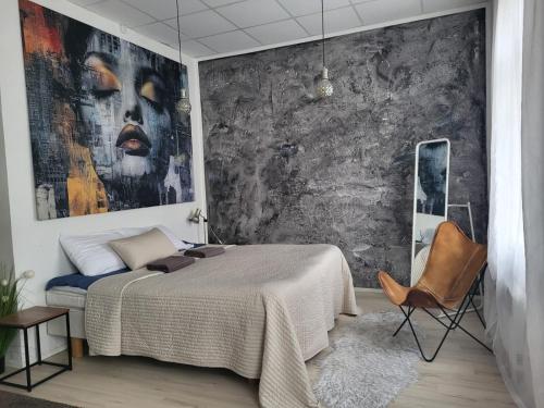 a bedroom with a bed and a painting on the wall at Aste loft house in Aste