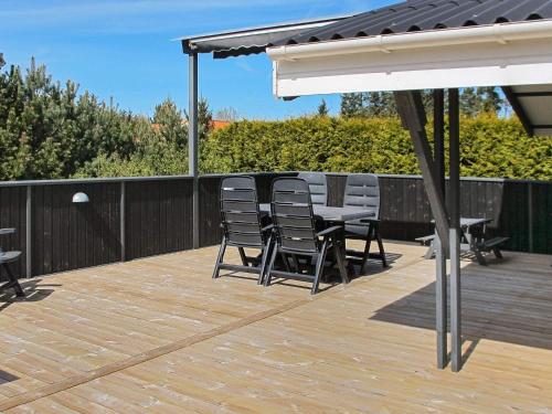 a patio with chairs and a table on a deck at Tranquil Oasis near Golf Course-By Traum in Hals