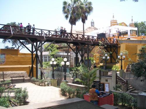 a bridge in a city with people walking on it at Casita Libertad Barranco in Lima