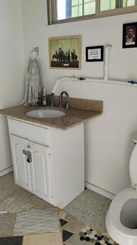 a bathroom with a sink and a toilet at Arlo's AFrame in Joshua Tree