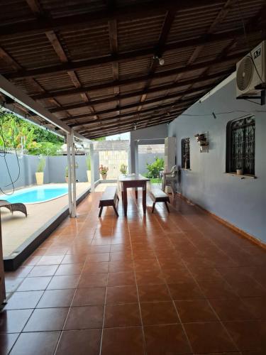 a patio with a table and chairs and a pool at Residencial Celedone in Boa Vista
