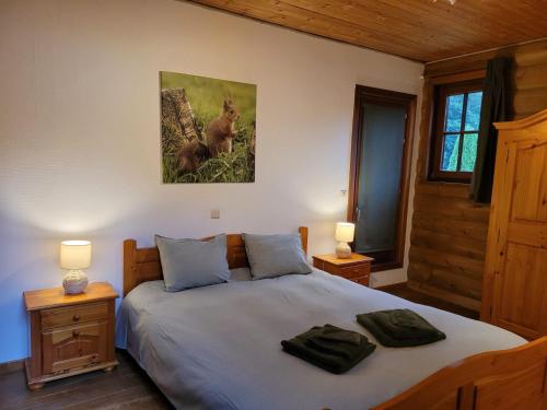 a bedroom with a bed with two towels on it at Gite de Liresse 