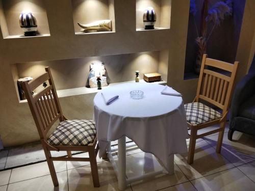 a table with two chairs and a white table cloth on it at Centro Citta Hotel in Cairo