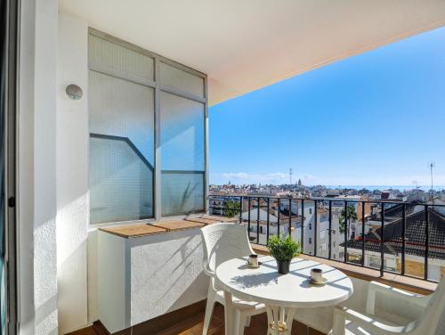 a balcony with a table and chairs and a view at Linda Vista Oasis Penthouse by Hello Homes Sitges in Sitges