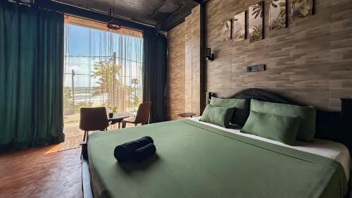 a bedroom with a large bed and a large window at Arana Weligama in Weligama