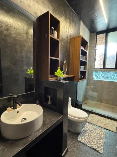 a bathroom with a sink and a toilet at Beach Trendy Lux Villa in Chicxulub
