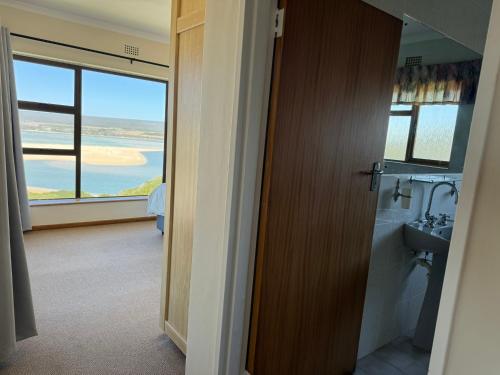 a bathroom with a sink and a view of the ocean at Amia in Witsand