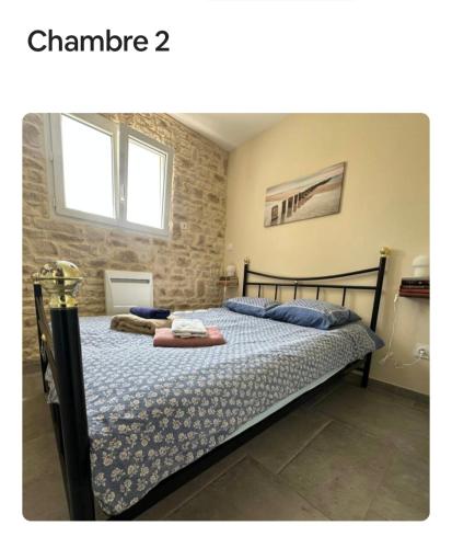 a bedroom with a bed in a room at Maison détente in Nonant