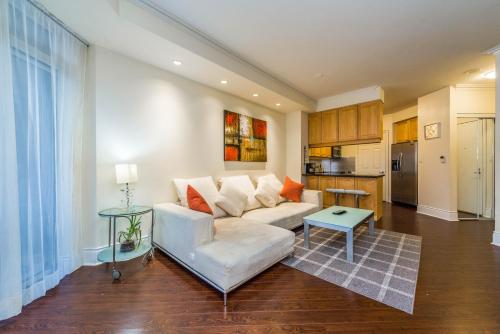 a living room with a white couch and a table at PlanURstay - Amazing 2BR & 2BTH - Near Square One Mall in Mississauga