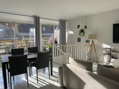 a living room with a table and chairs and a couch at le Nid d Annie in Sancerre