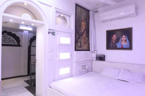 a white bedroom with a bed in a room at House of Raghuvansh in Jodhpur