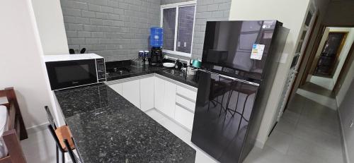 Et tv og/eller underholdning på Casa Completa com 2 Quartos Conforto e Espaço