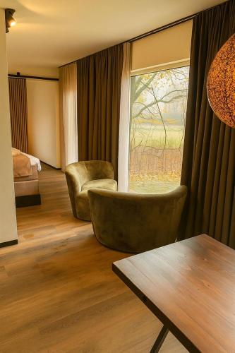 a living room with a chair and a window at Chalet Marter in Sellingen