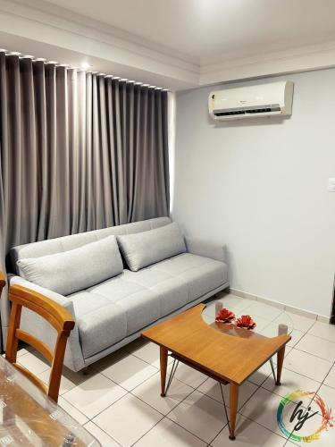 a living room with a couch and a coffee table at Ponta de Pedra 103 in Ilha da Restinga