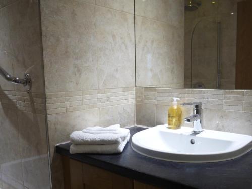 a bathroom with a sink and a shower at Deluxe Seaside Flat easy access in Westward Ho
