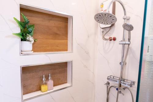 a bathroom with a shower with a sink at Ice Dragon Pool Villa ไอซ์ดราก้อน พูลวิลล่า in Ban Map Fakthong