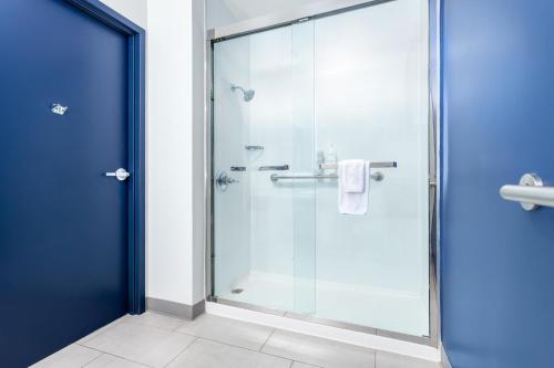 a shower with a glass door in a bathroom at Spark by Hilton Clarion in Clarion