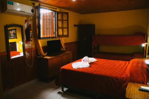 a hotel room with a bed and a mirror at Cabañas Quinta Las Ruedas in San Isidro
