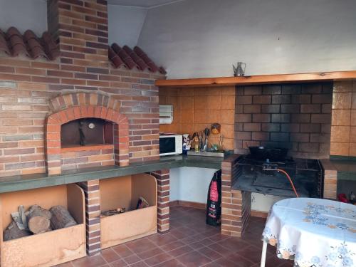a kitchen with a brick oven with a table at Finca roxana in Elda