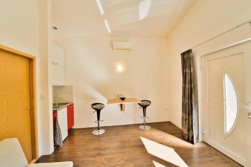 a room with a table and two stools at Apartment Chantal in Mostar